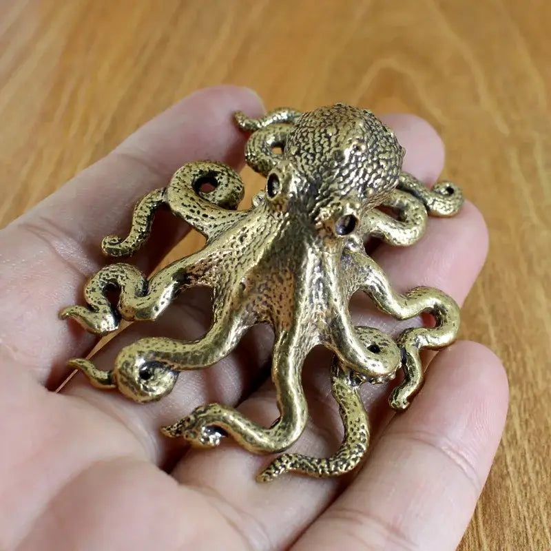 Golden brass octopus sculpture with textured skin and coiled tentacles for living room decor by decorbites