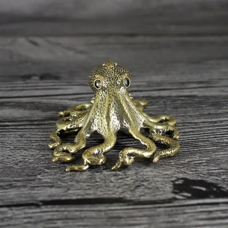 Golden brass octopus sculpture with textured skin and black bead eyes for elegant living room decor by decorbites