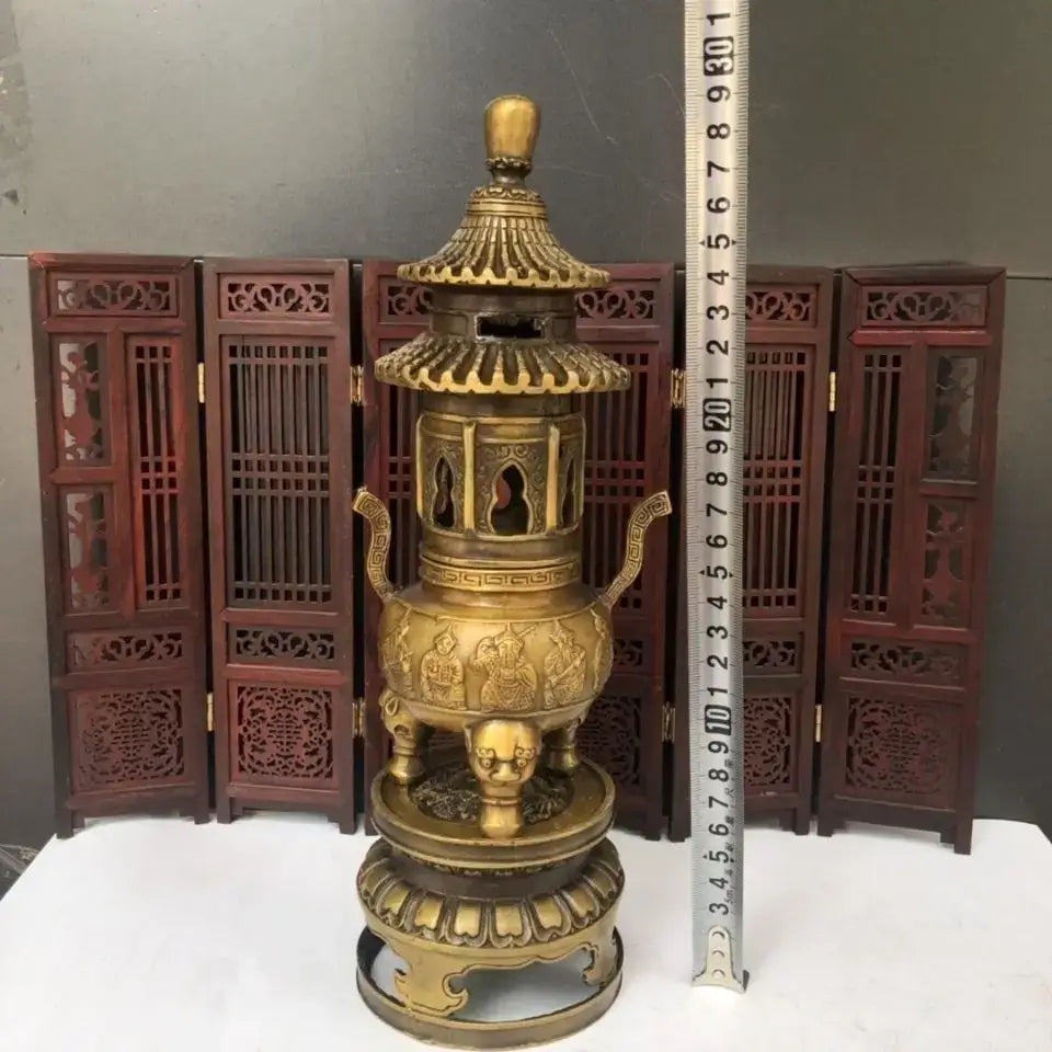 Golden brass three tiered tower incense burner with intricate carvings and pagoda-style lid for buddhist hall decor