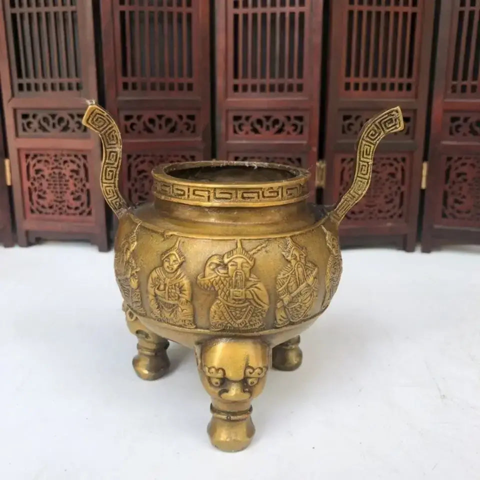 Golden brass three tiered tower incense burner with intricate relief carvings and tripod furnace animal feet design