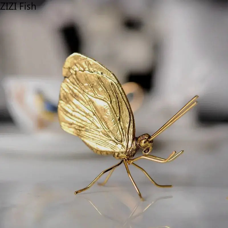 Golden butterfly ant miniature metal figurine with intricate wing detailing and slender metallic legs for living room decor