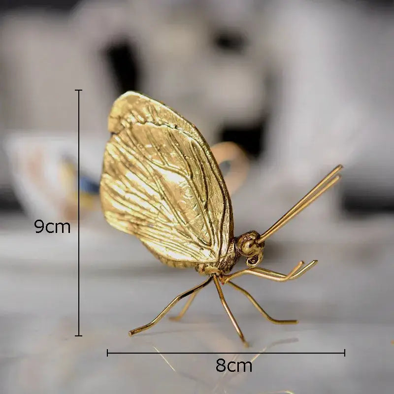 Golden metal butterfly ant miniature figurine with detailed wing veins and slender legs for living room decor