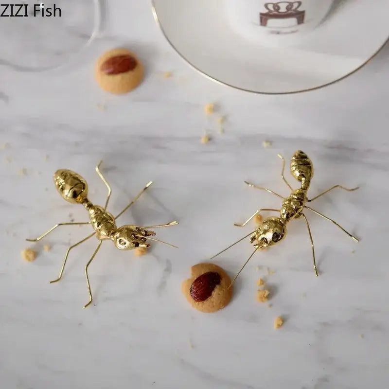 Two golden butterfly ant miniature metal figurines with intricate details and articulated limbs for living room decor