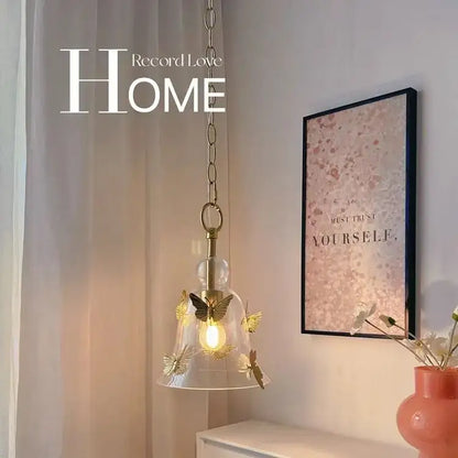 Clear glass pendant lamp with gold-toned metal butterflies and brass-finished chain for dining room bedhead glass pendant