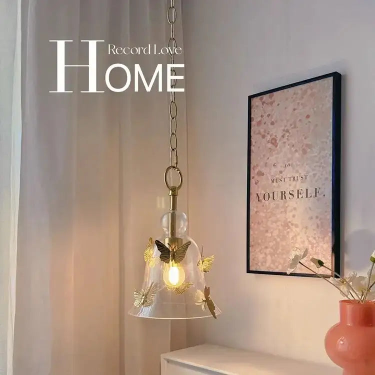 Clear glass pendant lamp with gold-toned metal butterflies and brass-finished chain for dining room bedhead glass pendant