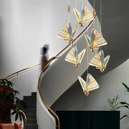 Elegant gold-toned butterfly led pendant light with iridescent blue and yellow wings by decorbites for bedroom and dining room decor