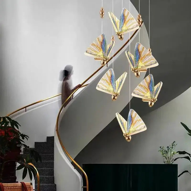 Elegant gold-toned butterfly led pendant light with iridescent blue and yellow wings by decorbites for bedroom and dining room decor