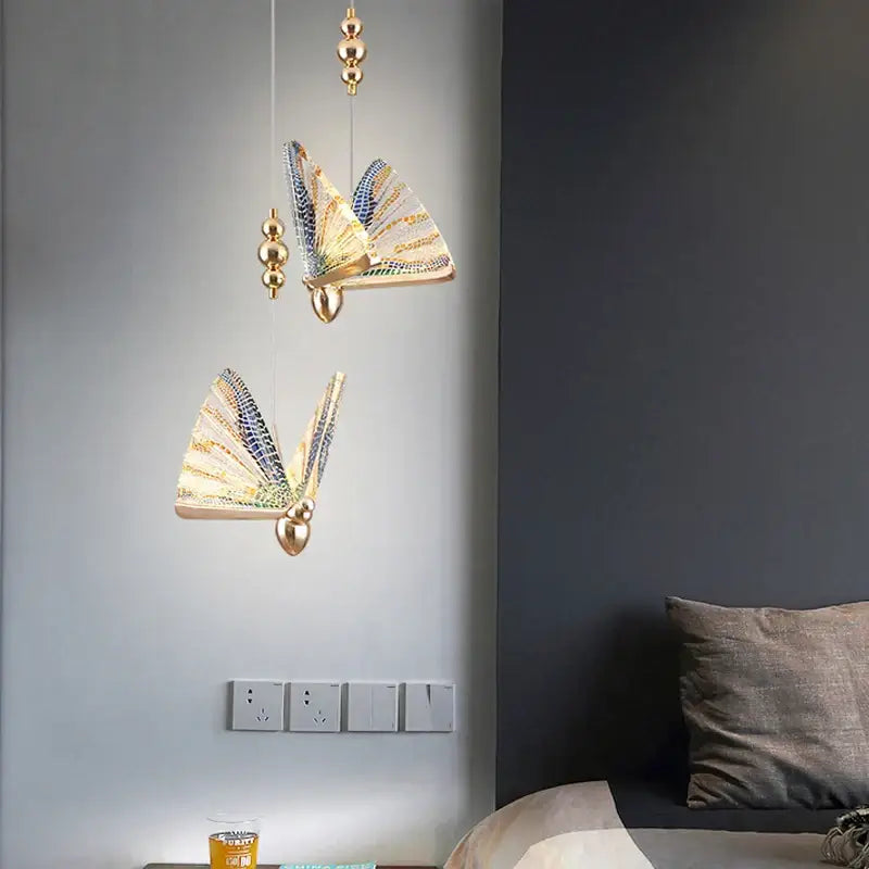 Gold-toned butterfly led pendant light with intricate blue and gold wings by decorbites for bedroom and dining room decor