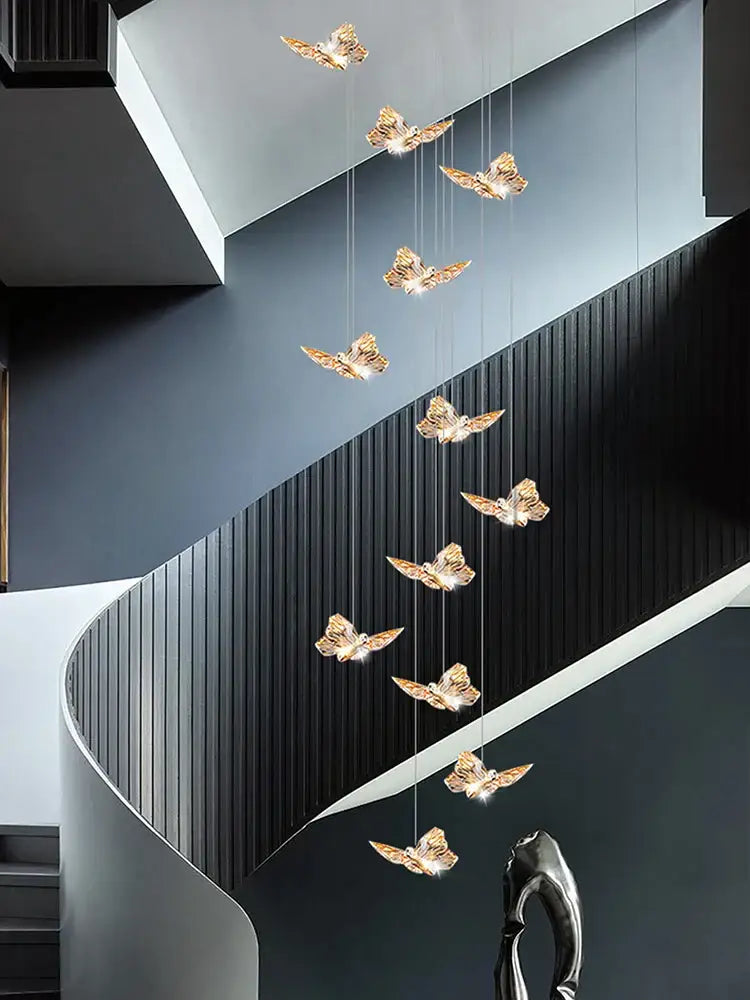 Golden butterfly chandelier pendant lights hang in a cascading arrangement ideal for butterfly chandelier staircase decor