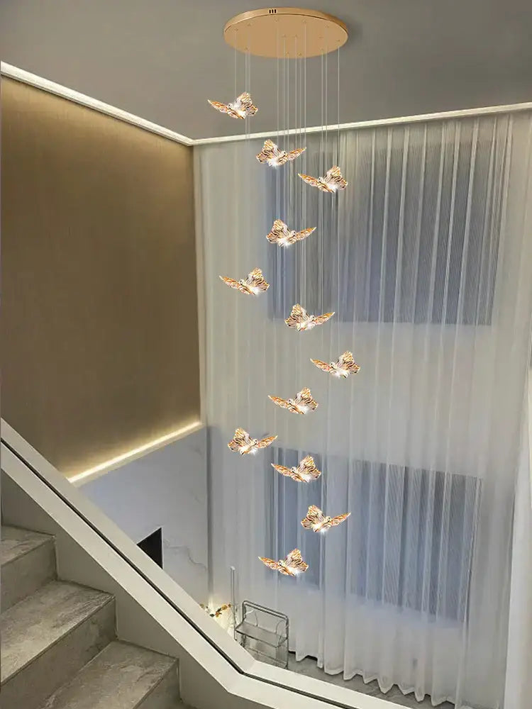 Golden butterfly pendant light with illuminated wings hanging from a circular ceiling fixture butterfly chandelier staircase