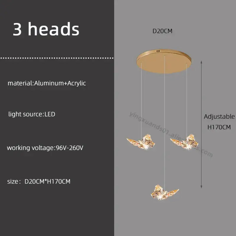 Gold-colored butterfly chandelier pendant light with three illuminated heads suspended from aluminum and acrylic mount