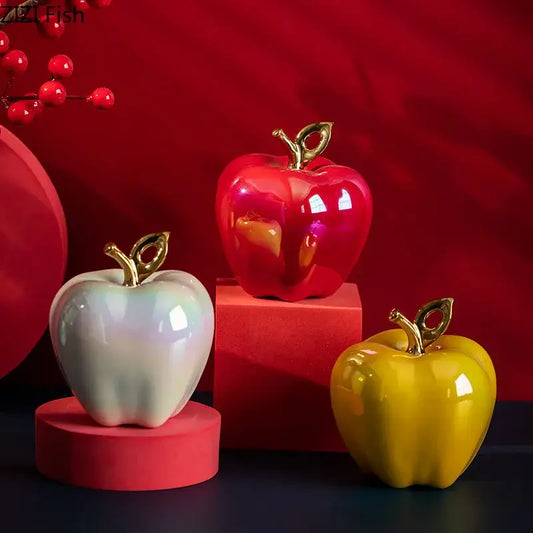 Shiny ceramic apple sculpture in red white and yellow with gold toned stems for living room table decor