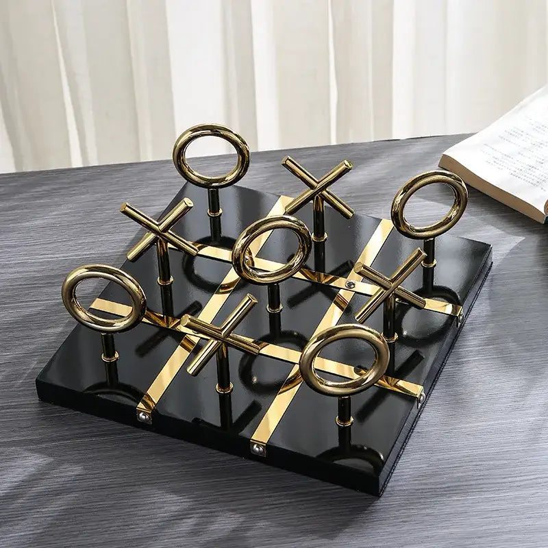 Decorbites golden chessboard metal handicraft tic-tac-toe set with gold circular and cross pieces on black base for living room decor