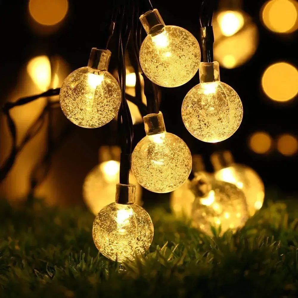 Warm golden crystal ball solar fairy lights with crackled glass texture for enchanting garden decor
