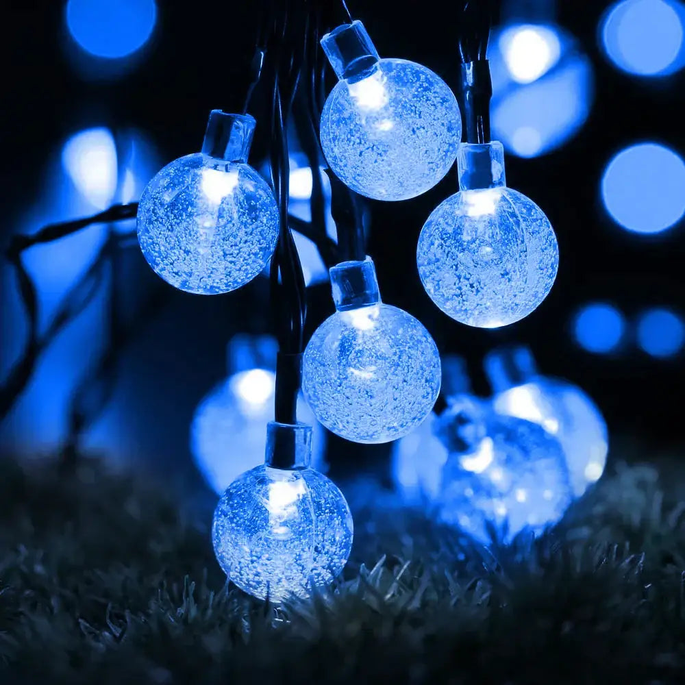 Blue globe-shaped solar fairy lights with frosty translucent finish golden crackled glass crystal ball decor