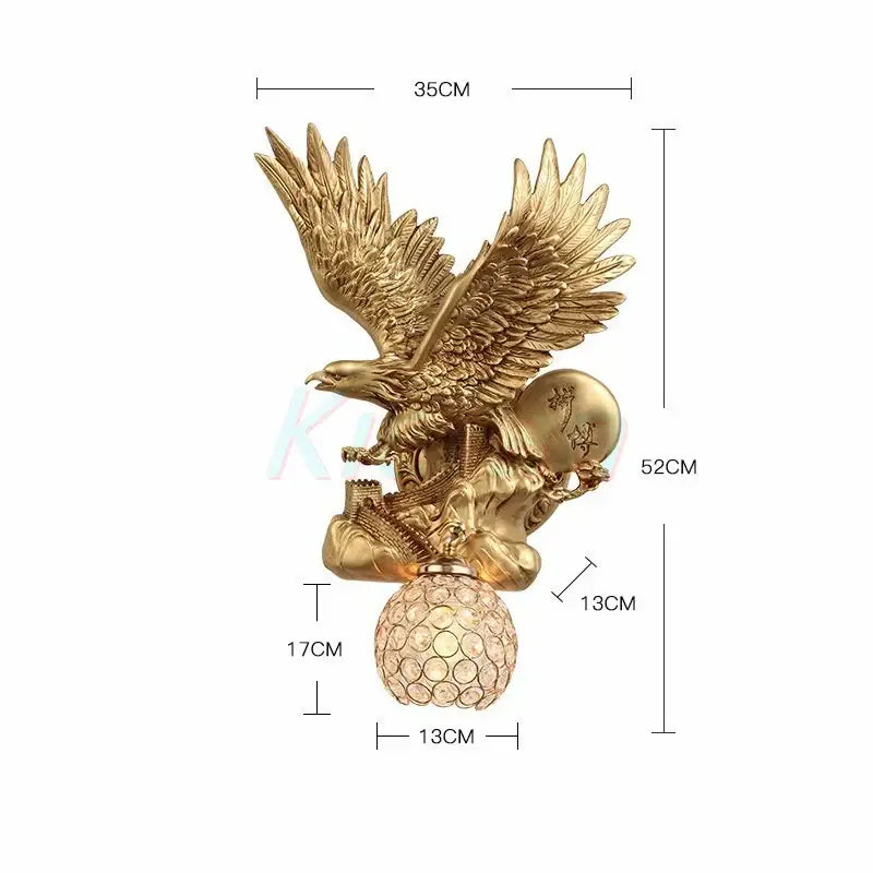 Golden crystal eagle wall lamp with detailed feathering perched on crystal sphere holding ornate globe for living room decor