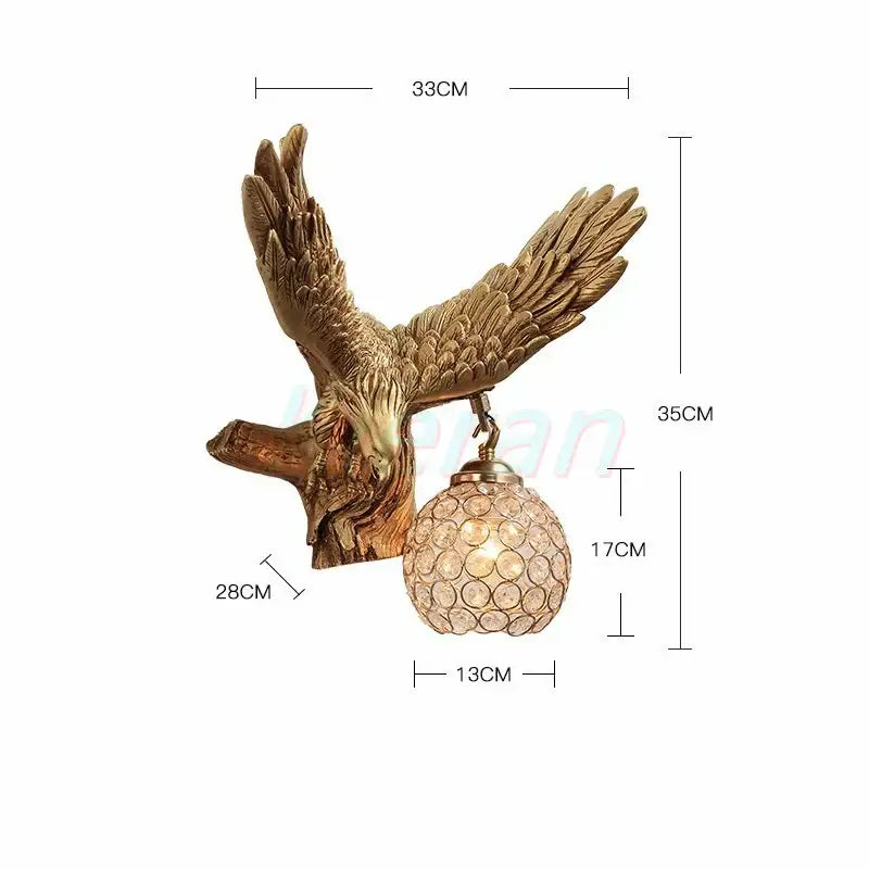 Golden crystal eagle wall lamp featuring detailed feathered wings and a textured spherical crystal globe shade for living room decorbites crystal eagle
