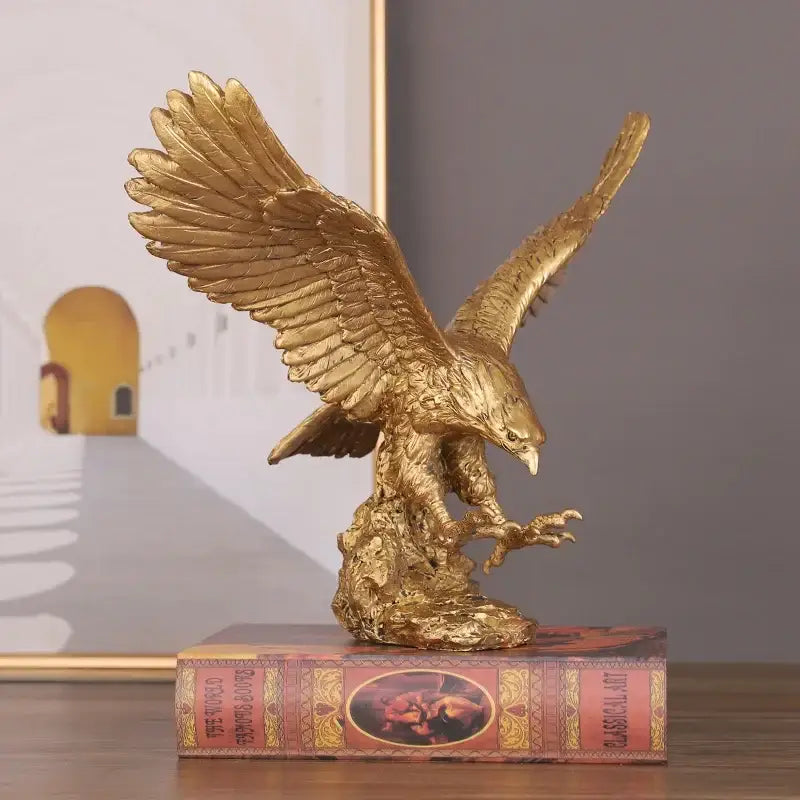 Golden dapeng eagle resin statue with detailed feathering and outstretched wings perched on rocky base decorbites dapeng eagle
