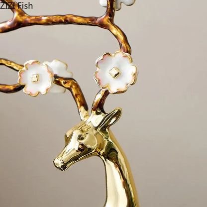 Golden ceramic decorbites deer antlers statue with branching antlers adorned with white porcelain blossoms for living room decor