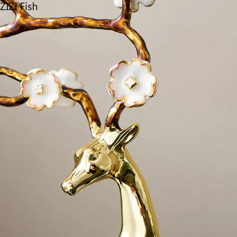 Golden ceramic decorbites deer antlers statue with branching antlers adorned with white porcelain blossoms for living room decor