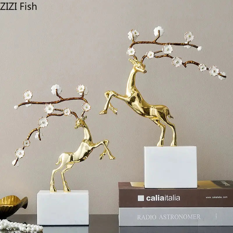 Golden deer antlers statue with delicate white blossoms on branching antlers on white bases for decorbites deer decor