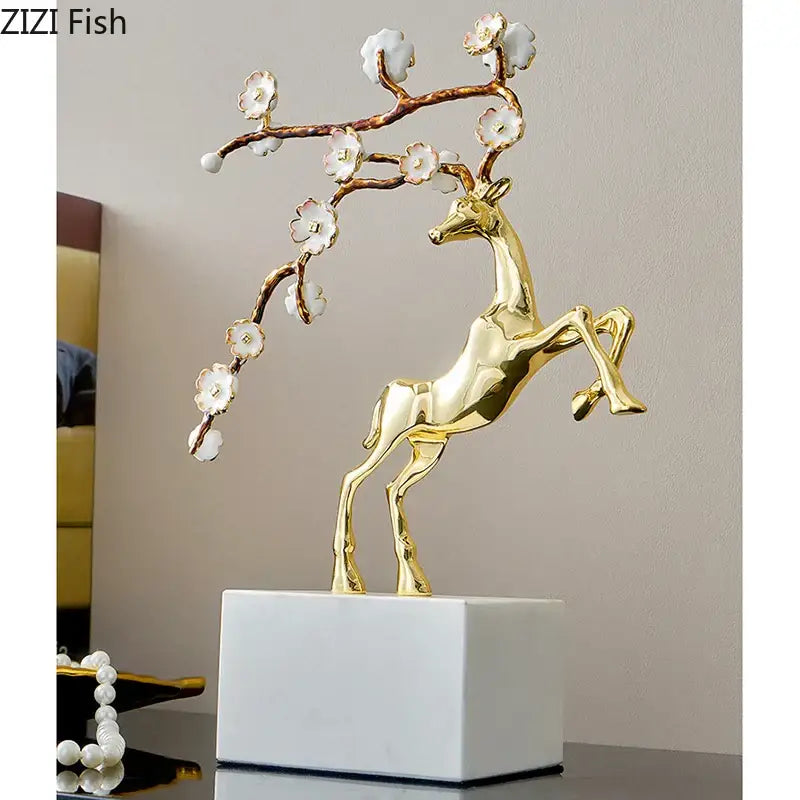 Golden deer antlers statue with delicate white blossoms on antlers standing on white marble base for living room decorbites deer antlers