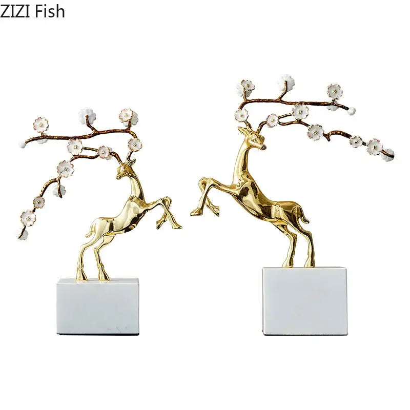 Golden deer antlers statue with delicate white blossoms on branching limbs standing on white marble base decorbites deer antlers