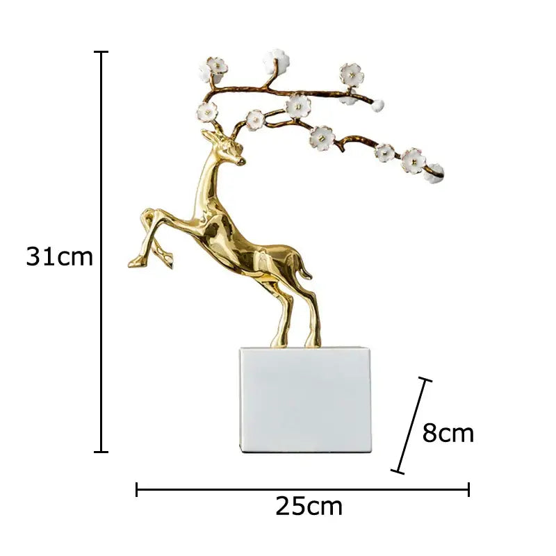 Golden deer antlers statue with delicate white blossoms on antlers standing on a sleek silver base for living room decorbites deer