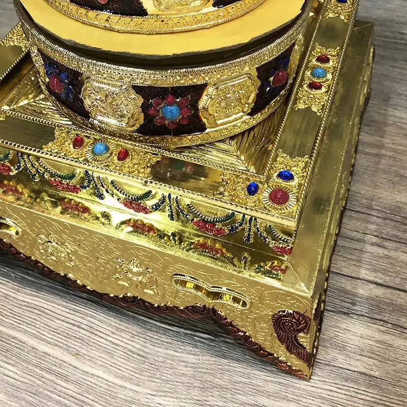 Golden ornate eight auspicious buddha alloy plates with embossed patterns and gemstone accents for temple meditation