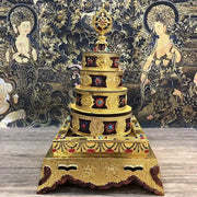 Golden multi-tiered buddhist stupa with intricate engravings and gemstone inlays for eight auspicious buddha alloy plates
