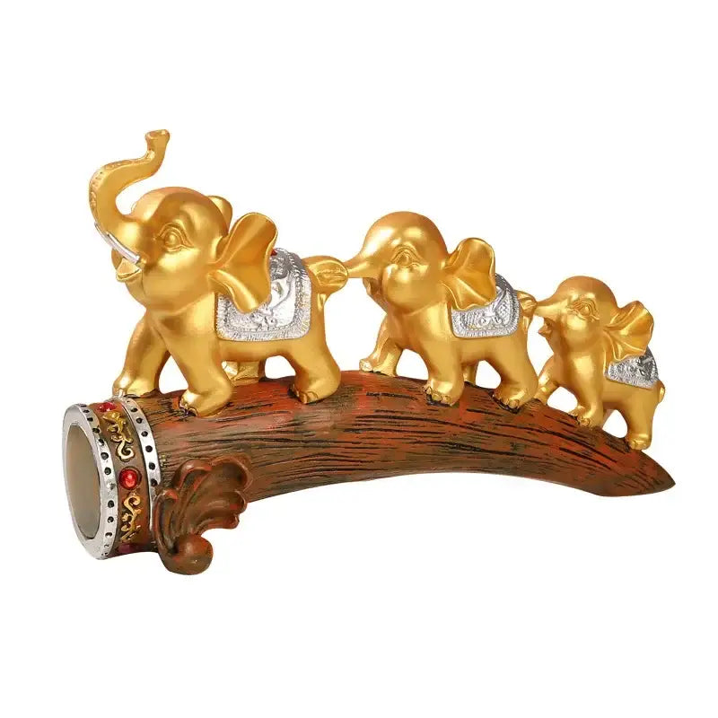 Golden elephant resin ornament with silver saddle accents on curved wooden log base decorbites elephant resin decor