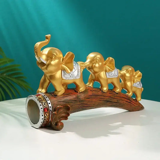 Golden elephant resin ornament with silver accents and decorative saddle on carved wooden log base decorbites elephant resin