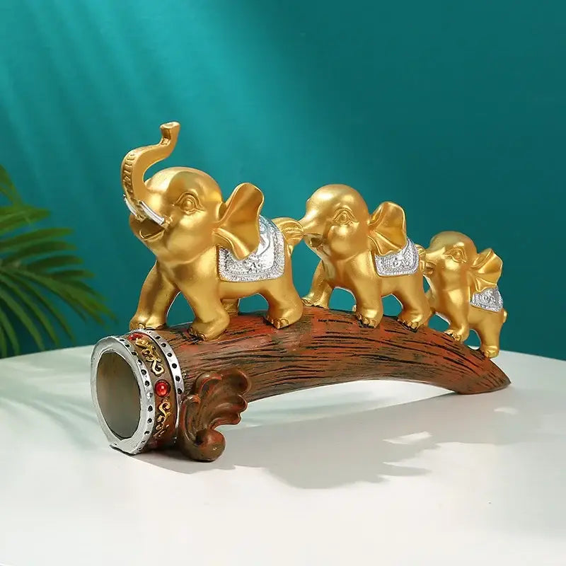 Golden elephant resin ornament with silver accents and decorative saddle on carved wooden log base decorbites elephant resin