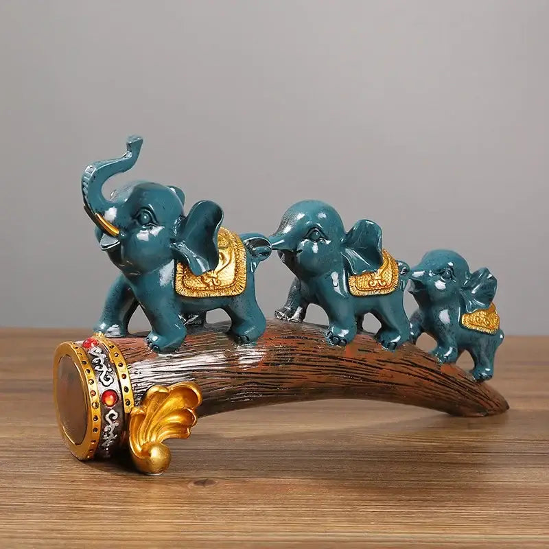 Teal and gold elephant resin ornament family figurine set on decorative log base by decorbites elephant resin