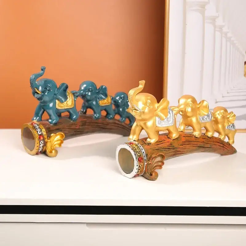 Two decorbites elephant resin ornament sets in teal gold and gold silver on detailed wooden log bases for living room decor
