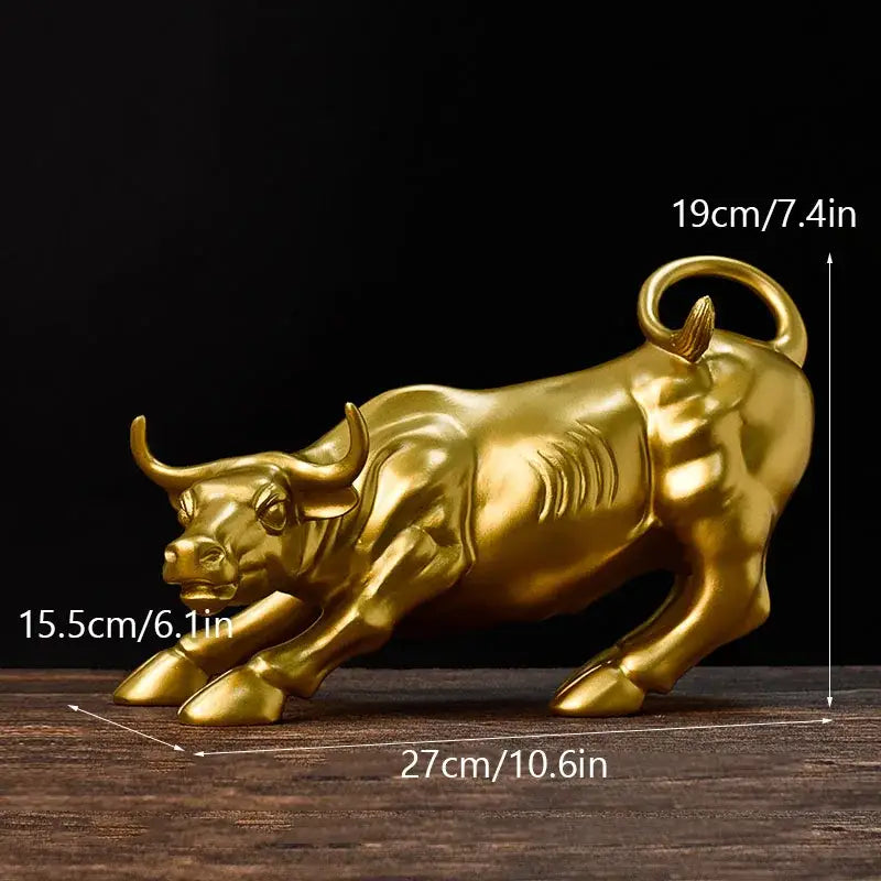Golden metallic fortune resin sculpture of a charging bull with detailed musculature for office desk decor
