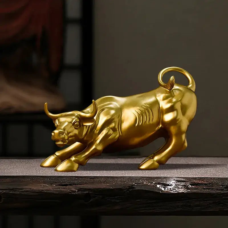 Golden metallic bull fortune resin sculpture with detailed musculature and curved horns for office desk decor