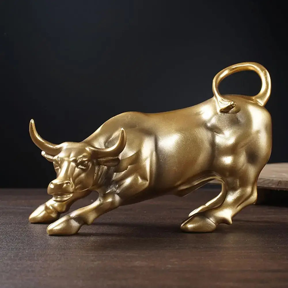 Golden fortune resin sculpture of a metallic bull with polished reflective surface and curved tail loop for office desk decor