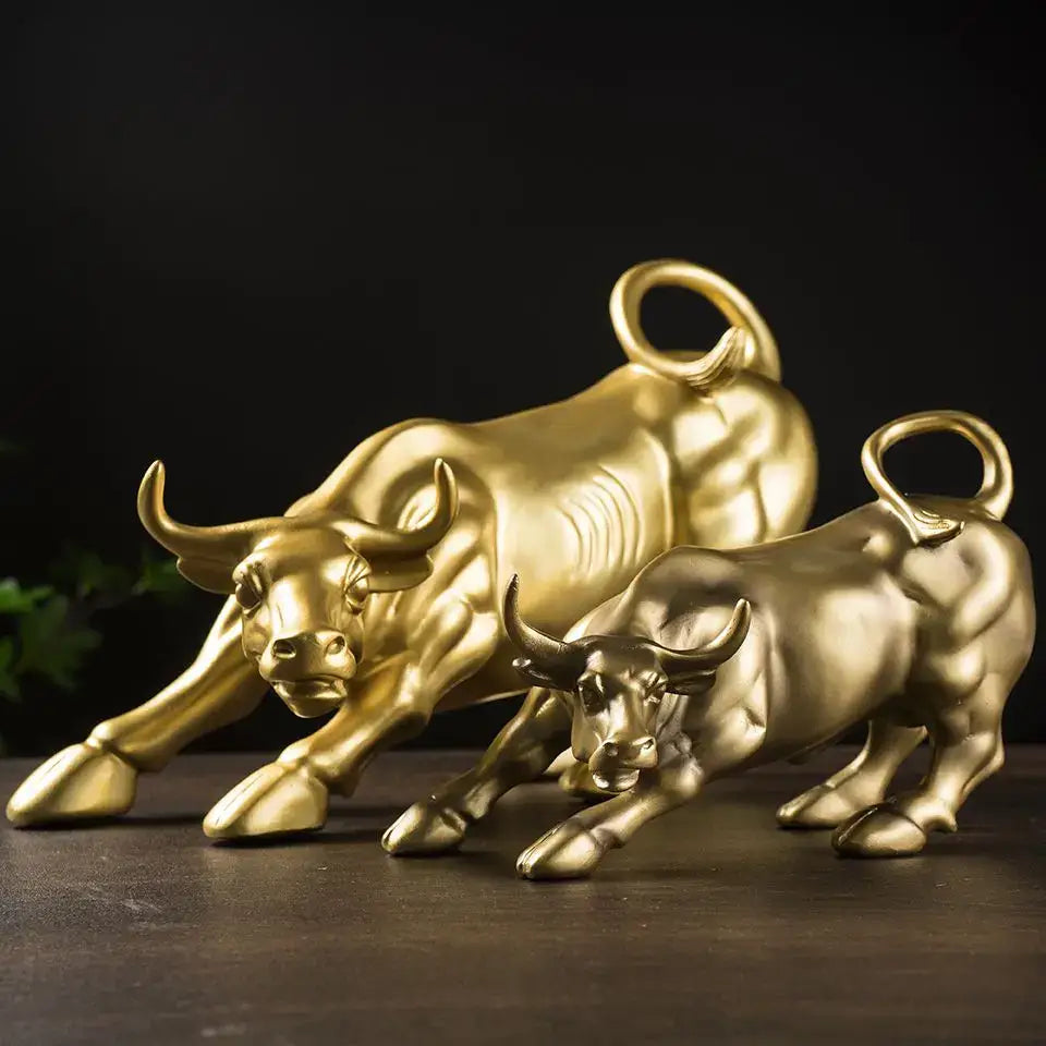 Two golden fortune resin sculpture bulls with detailed musculature and curled tails for office desk decor