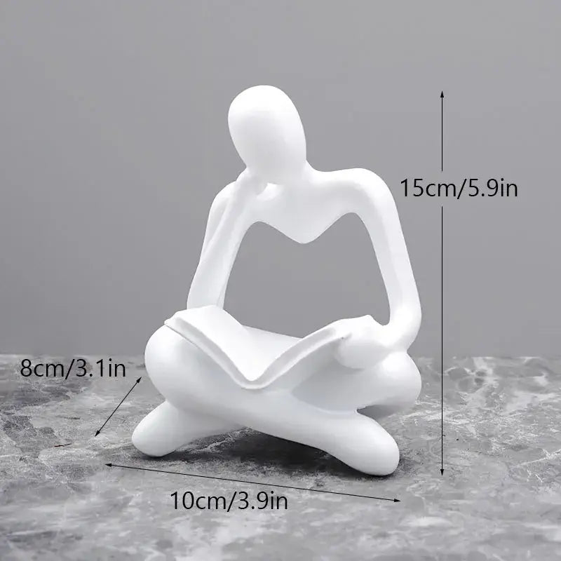White resin figurine of seated human holding open book golden glossy abstract thinker resin office decorbites abstract thinker