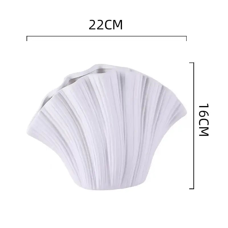 White ceramic vase shaped like a scallop shell with vertical ridges for decorbites gradient shell ceramic decor