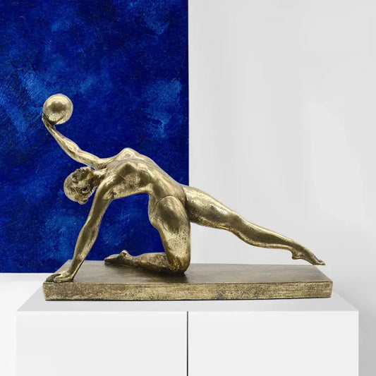 Golden gymnast figurine metallic sculpture in dynamic pose holding ball on rectangular base for living room decorbites decor