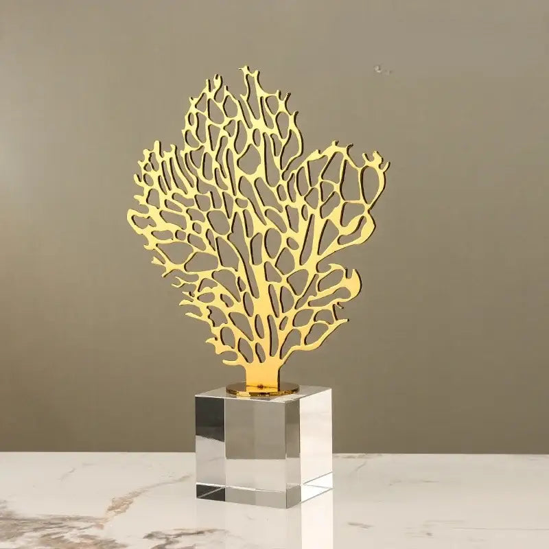 Golden hollow tree coral sculpture with a clear crystal base for elegant living room decor by decorbites golden hollow