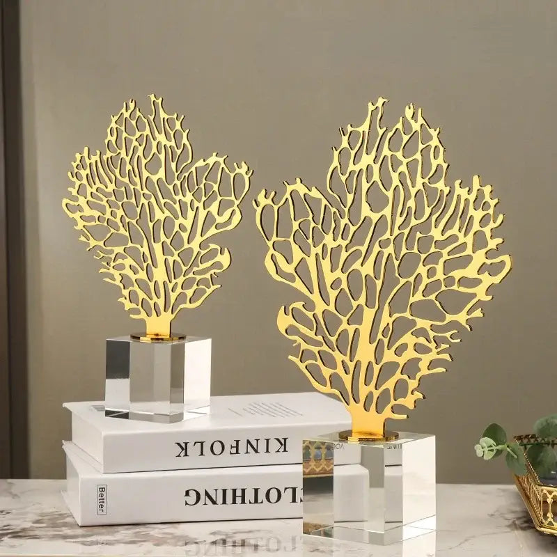 Two golden hollow tree coral sculptures with intricate cut-out patterns on clear acrylic bases for living room decorbites decor