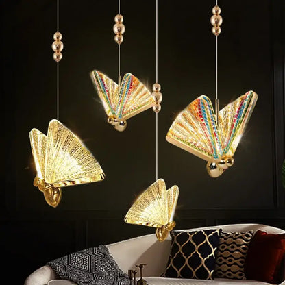 Golden iridescent butterfly pendant light with rainbow wings and metallic gold accents for living room decor