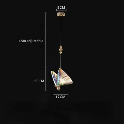 Golden iridescent crystal butterfly pendant lamp with iridescent wings and gold-toned metallic body for bedroom lighting