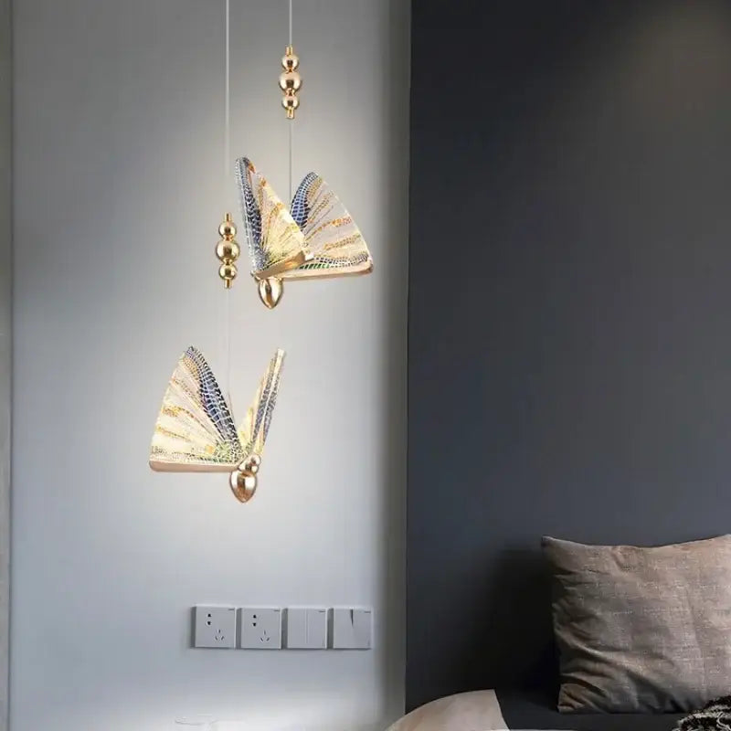Gold-toned decorbites crystal butterfly pendant lamp with iridescent wings and spherical accents for bedroom lighting