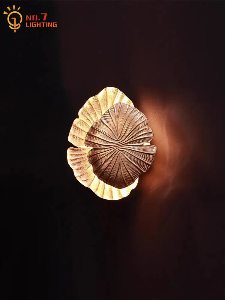 Golden leaf designer copper wall lamp with intricate veined detailing and warm glowing light for bedroom decorbites designer copper wall