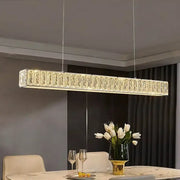 A sleek rectangular crystal chandelier with warm led lighting perfect for dining room decorbites golden led modern design