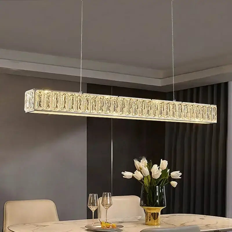 A sleek rectangular crystal chandelier with warm led lighting perfect for dining room decorbites golden led modern design